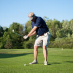 adult male golfer swinging club
